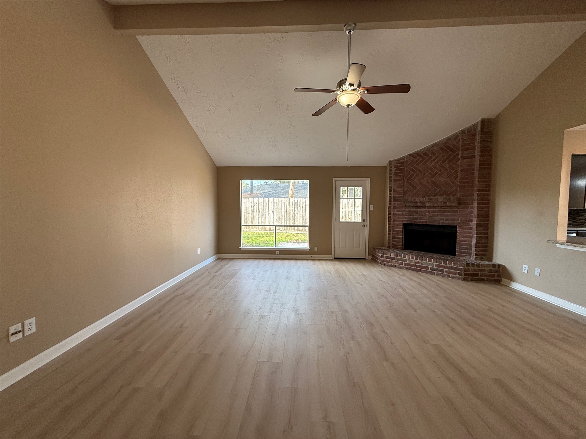 4738 Fleming Downe Lane Spring, TX 77388 - Photo 2 of 14 a view of empty room with a fireplace and wooden floor