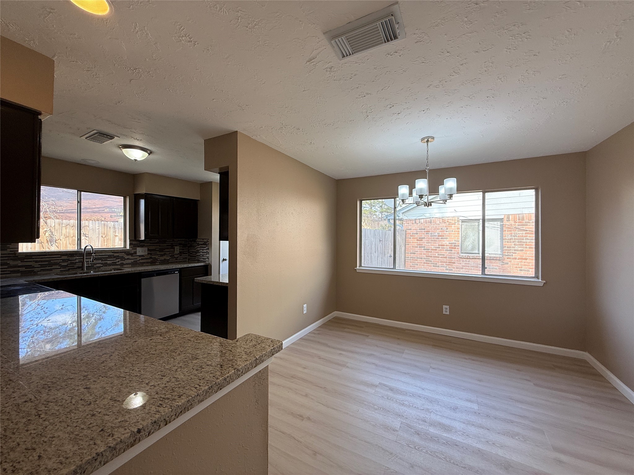 4738 Fleming Downe Lane Spring, TX 77388 - Photo 3 of 14 an empty room with wooden floor and windows