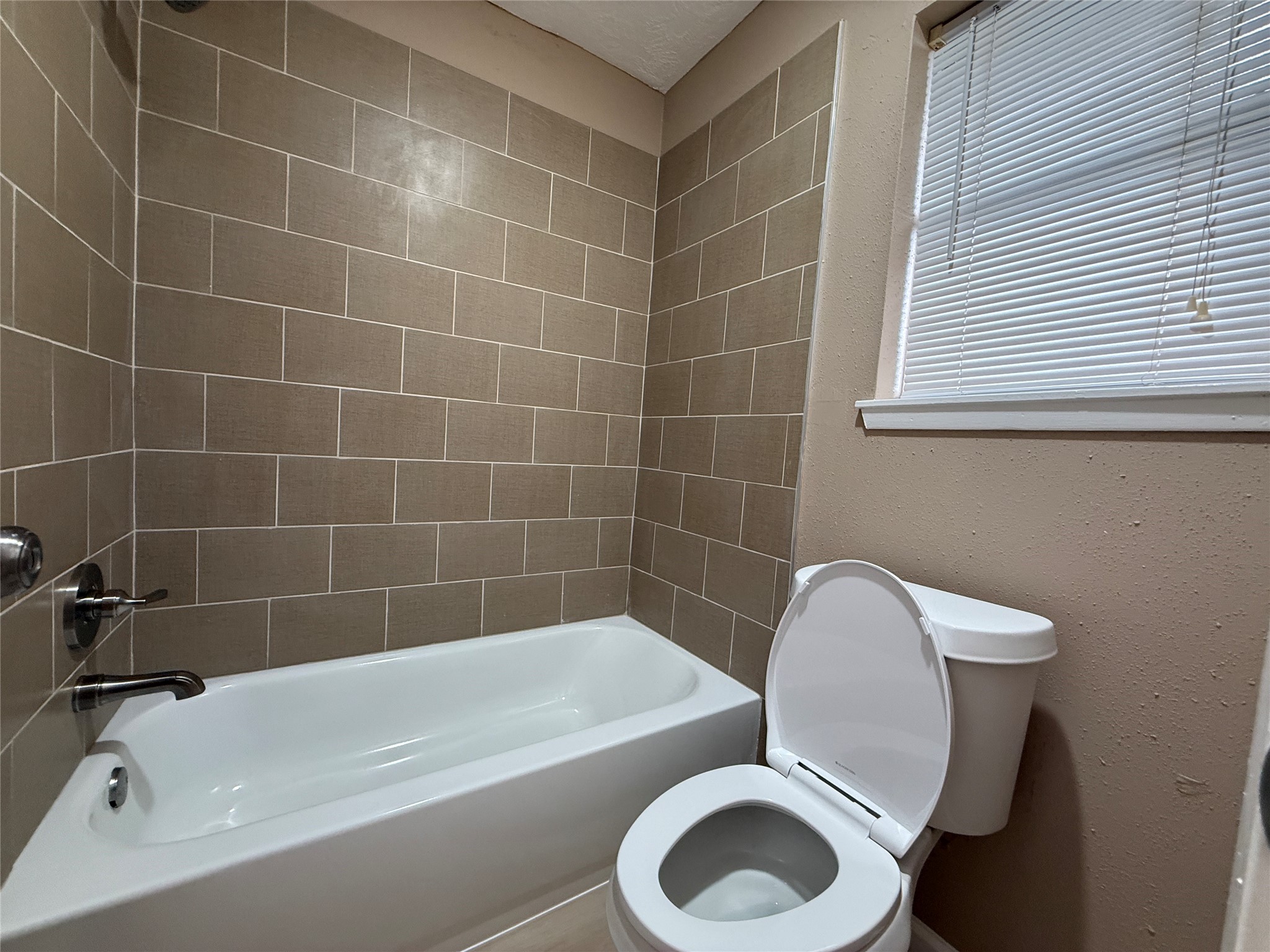 4738 Fleming Downe Lane Spring, TX 77388 - Photo 9 of 14 a white bath tub sitting next to a white toilet