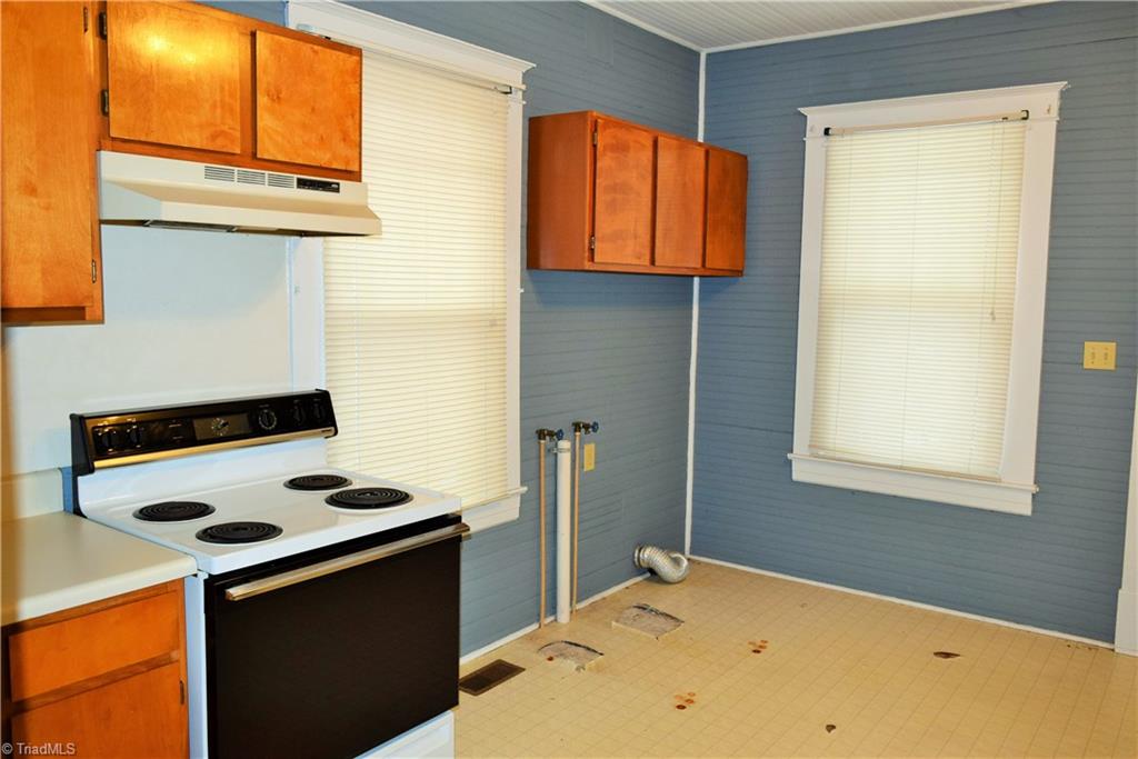 209 East Decatur Street Madison, NC 27025 - Photo 9 of 17 Large kitchen with bead board walls also houses the laundry hookup
