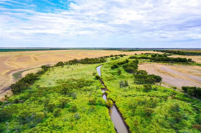 a view of a lake with a yard