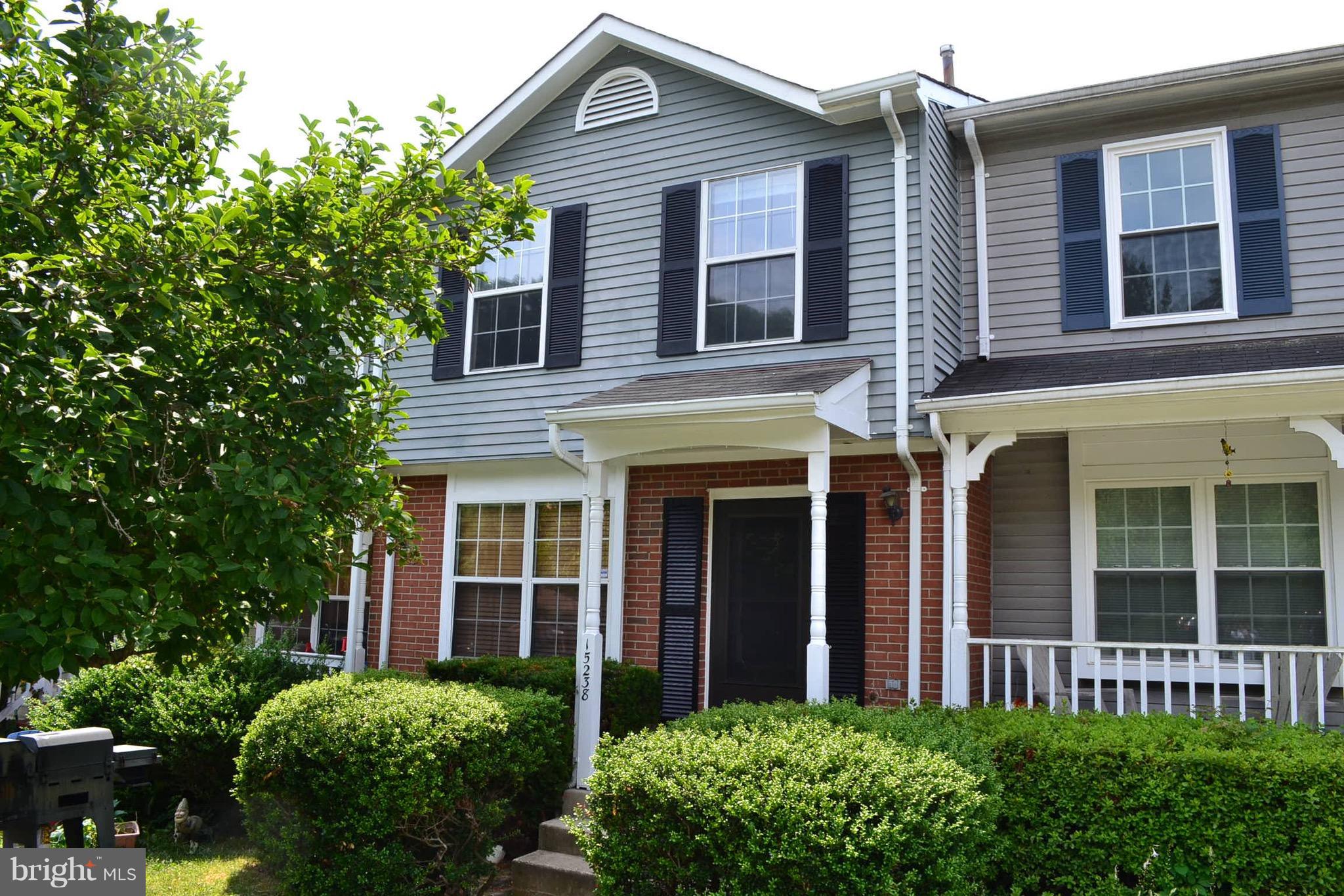 15238 Cloverdale Road Woodbridge, VA 22193 - Photo 1 of 19 front view of a brick house with a large windows and a yard