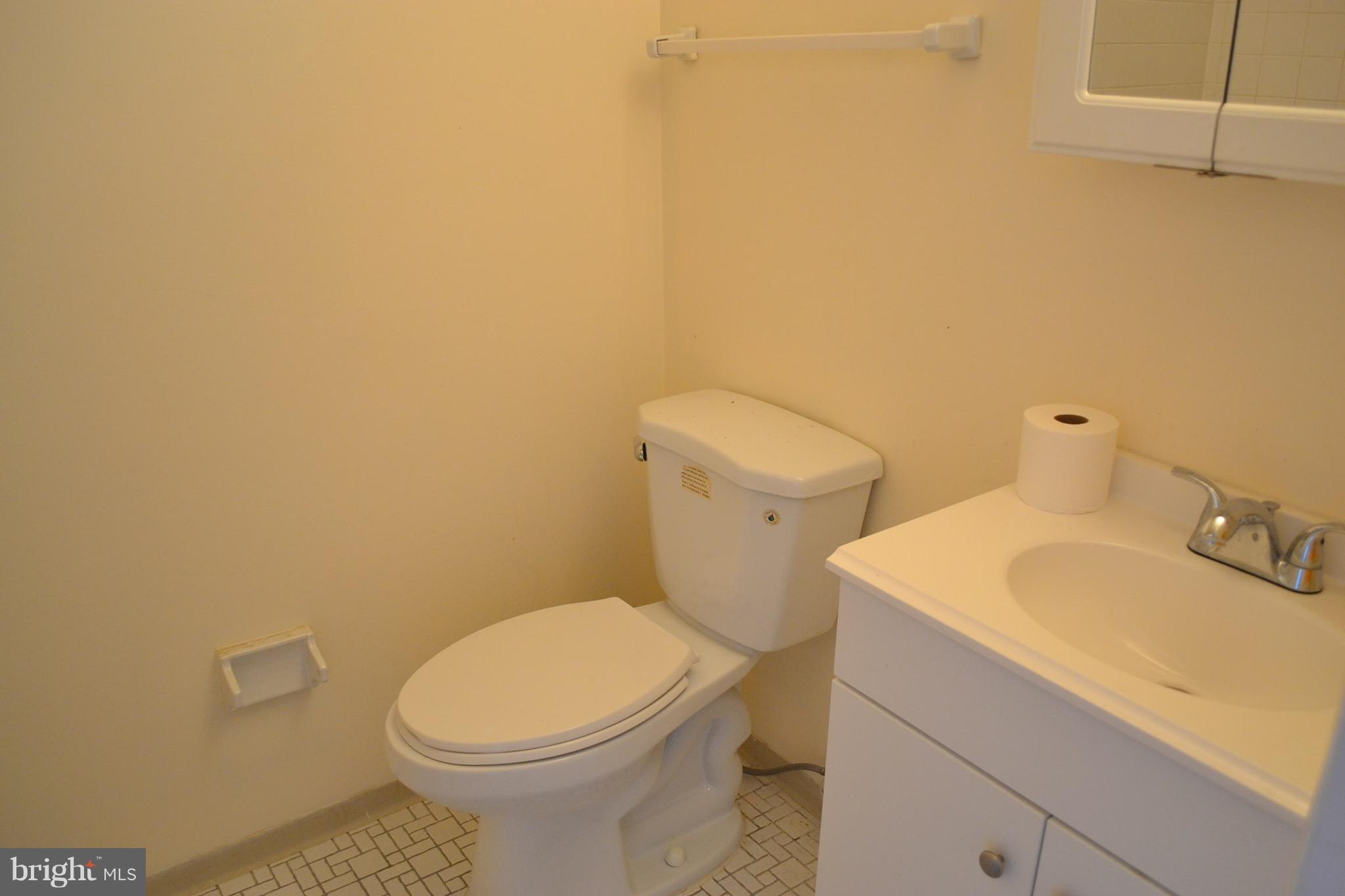 15238 Cloverdale Road Woodbridge, VA 22193 - Photo 12 of 19 a white toilet sitting next to a bathroom sink