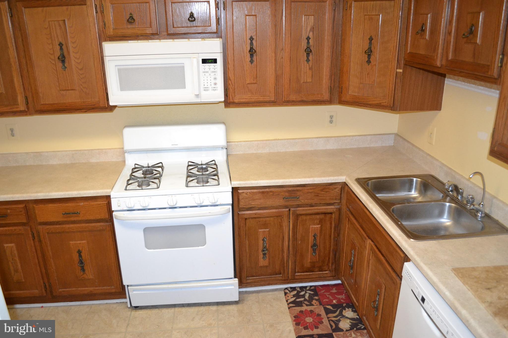 15238 Cloverdale Road Woodbridge, VA 22193 - Photo 18 of 19 a kitchen with a stove sink and cabinets