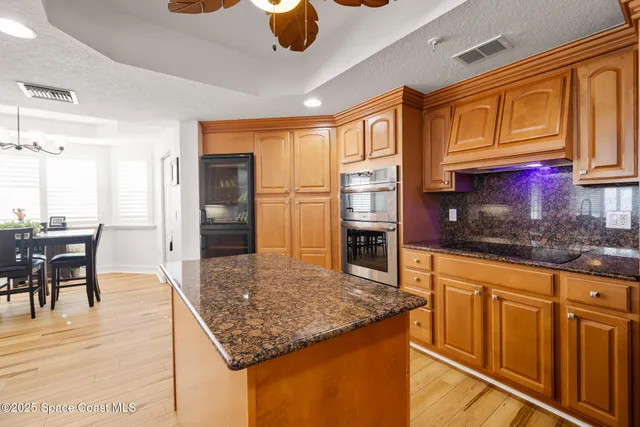 a kitchen with stainless steel appliances granite countertop a sink and cabinets