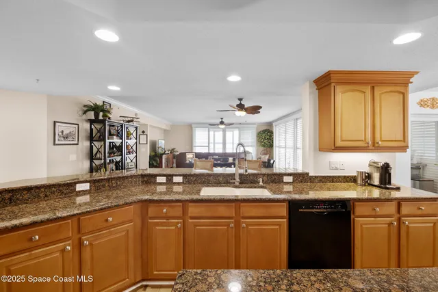 a kitchen with granite countertop a sink and cabinets