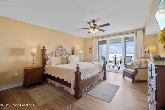 a spacious bedroom with a bed a window and couch