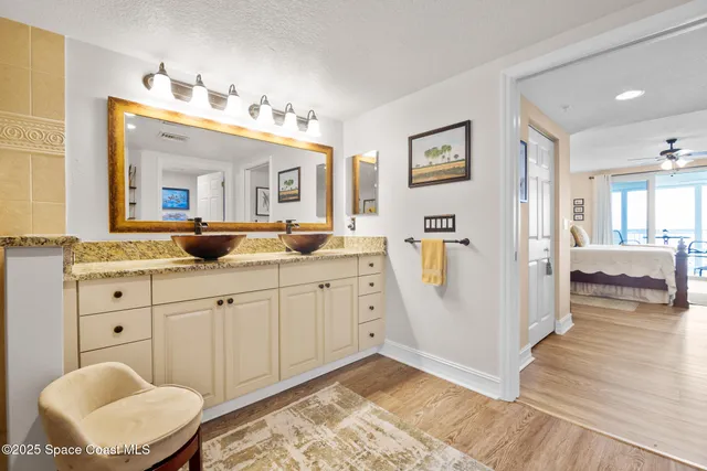 a spacious bathroom with a granite countertop sink and a mirror