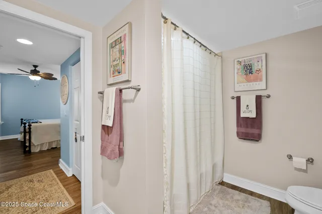 a living room with furniture a chandelier and a window
