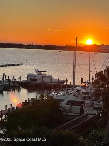 a living room with furniture and large windows