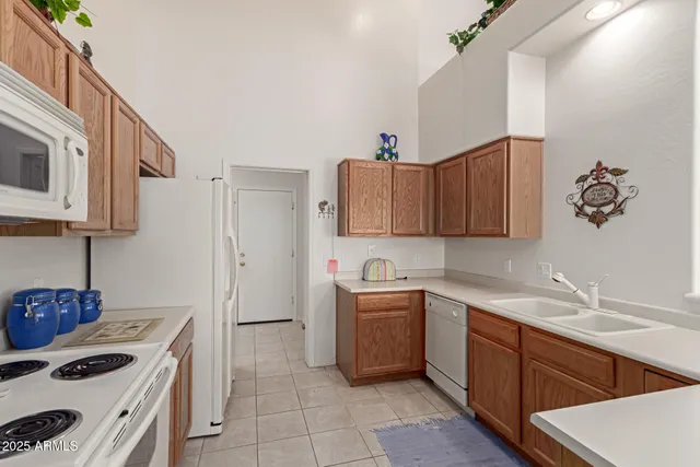 a kitchen with a sink cabinets and appliances