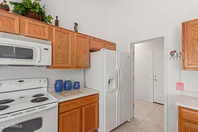 a kitchen with stainless steel appliances a refrigerator and a stove top oven