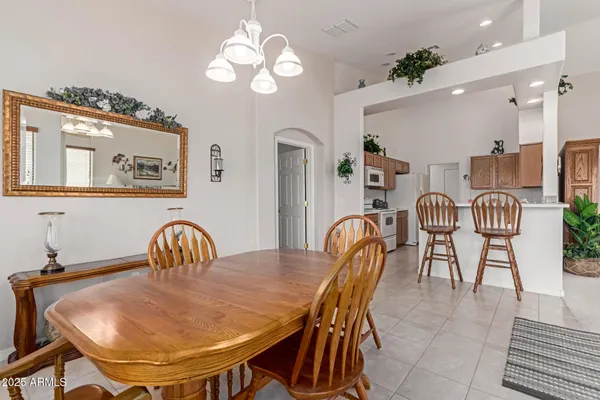 a dining room with furniture and chandelier