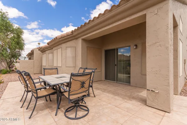 a patio with table and chairs
