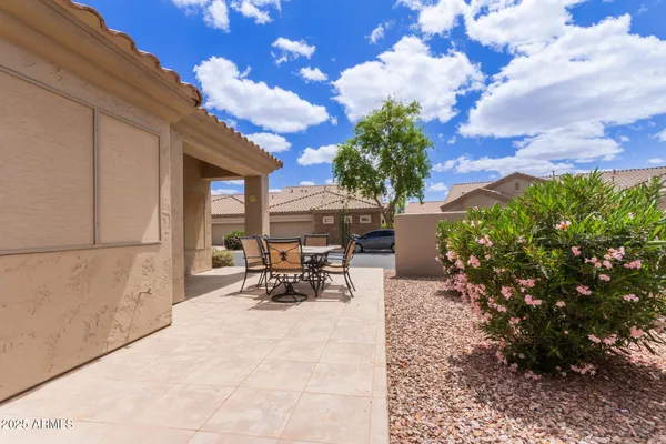 a view of a backyard with sitting area