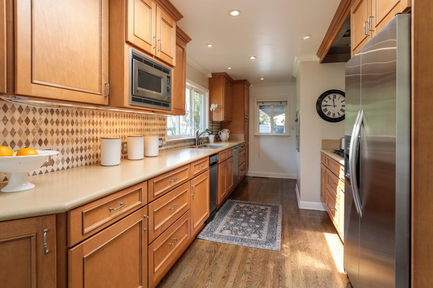 460 Cervantes Road Portola Valley, CA 94028 - Photo 12 of 45 a kitchen with stainless steel appliances granite countertop a refrigerator a sink dishwasher a stove and white countertops with wooden floor