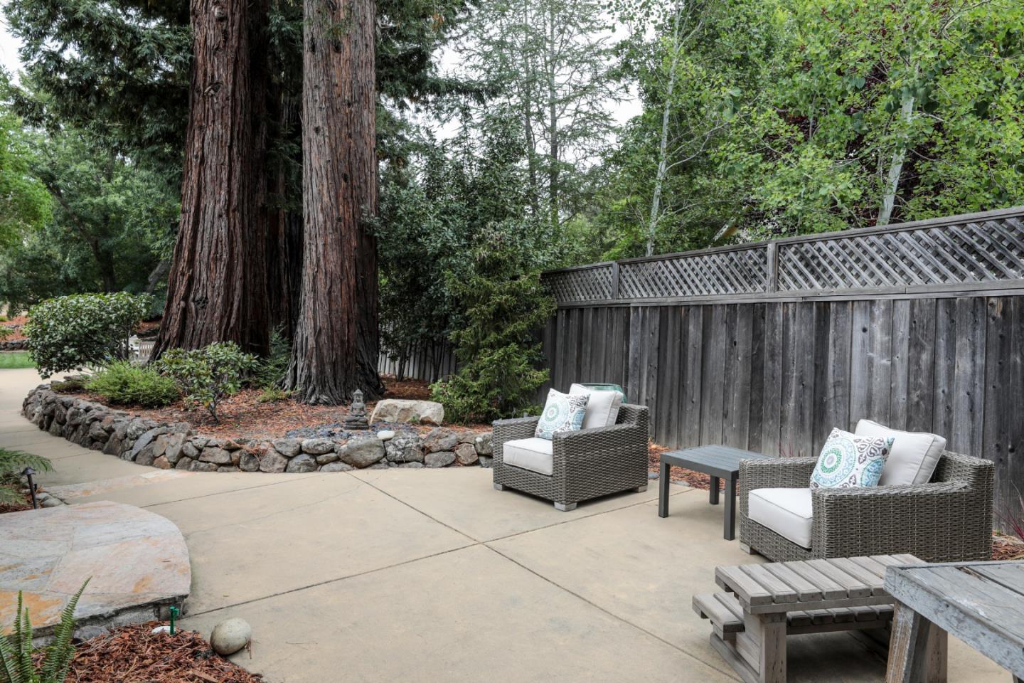460 Cervantes Road Portola Valley, CA 94028 - Photo 38 of 45 a backyard of a house with table and chairs