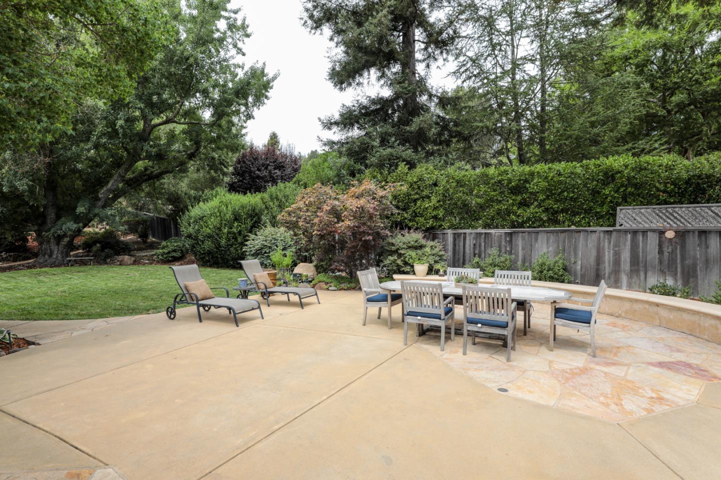 460 Cervantes Road Portola Valley, CA 94028 - Photo 40 of 45 a view of a patio with table and chairs potted plants and a large tree
