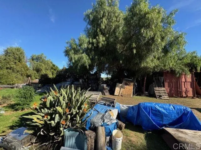 a view of backyard with outdoor seating and green space