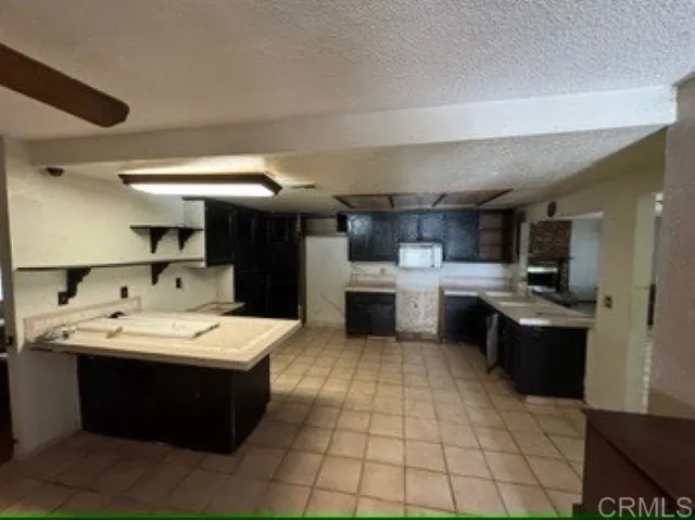 a kitchen with a sink a stove and chairs