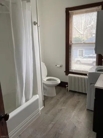 a bathroom with a toilet a sink and a window