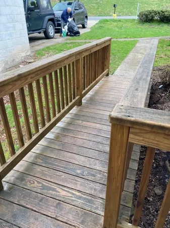 a view of a porch with wooden floor and fence