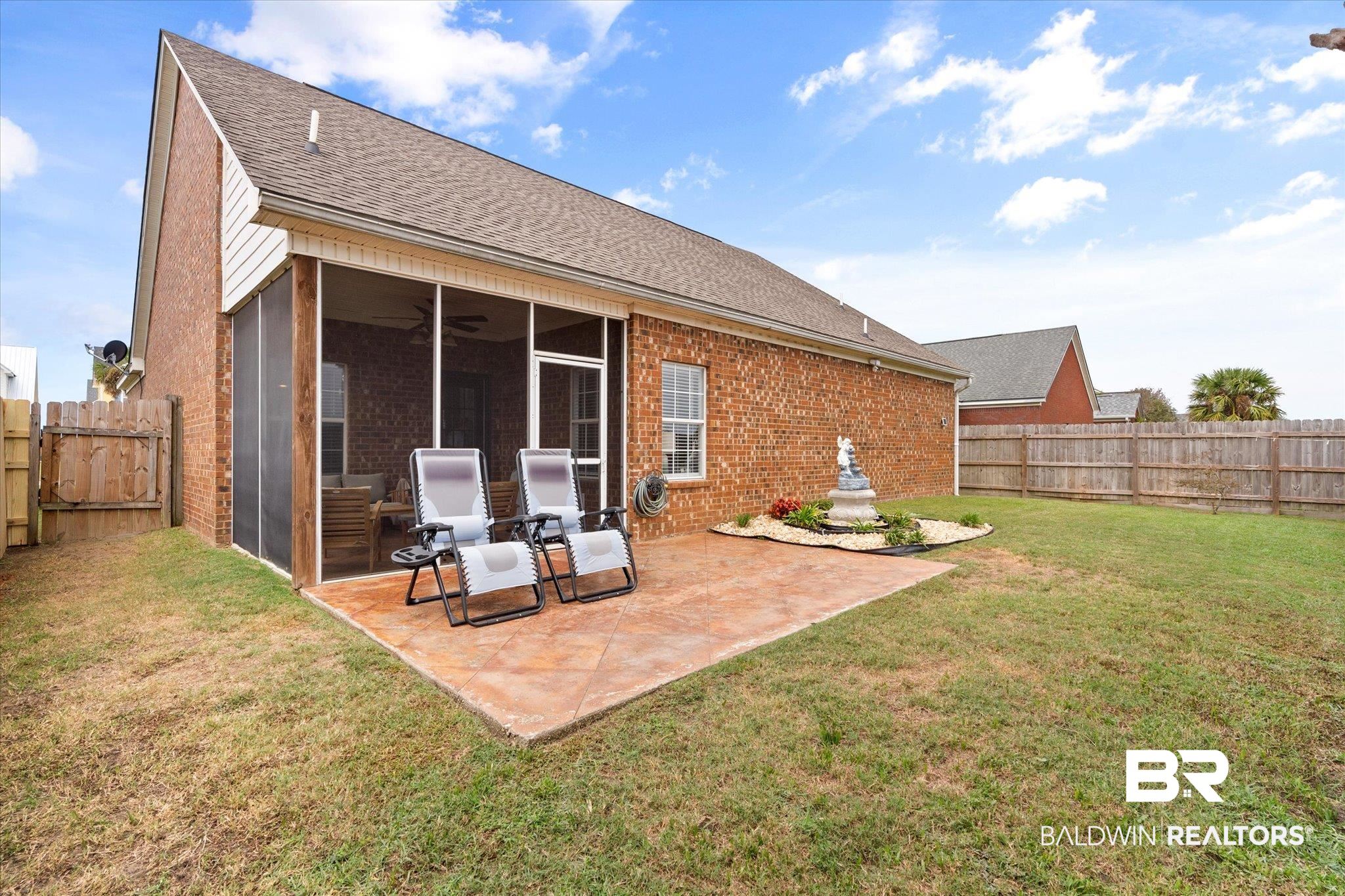 3876 Emerille Drive Foley, AL 36535 - Photo 27 of 31 Back of house with a yard, a sunroom, and a patio