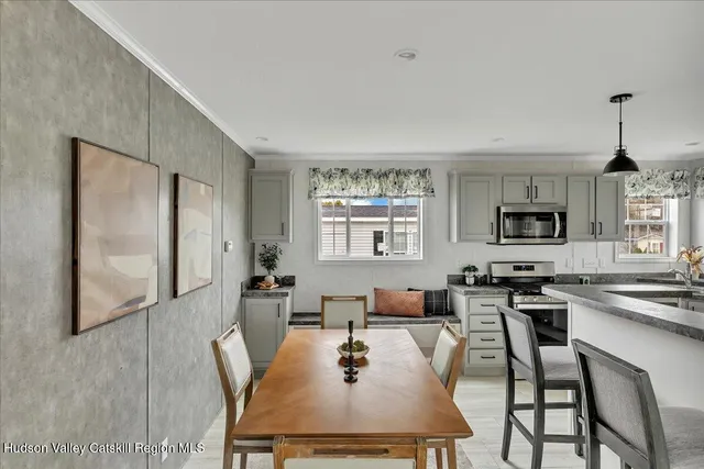 a dining room with wooden floor a glass table and chairs