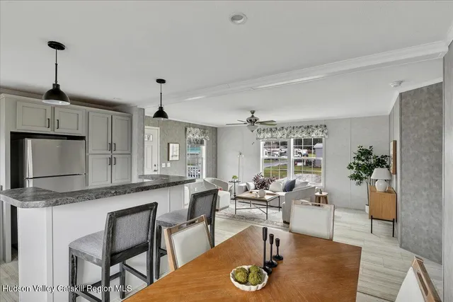 a living room with granite countertop furniture a dining table and chairs with kitchen view