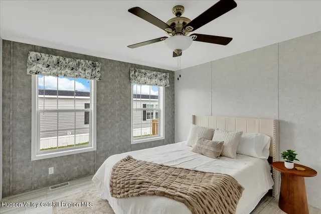 a bedroom with a large bed and a window