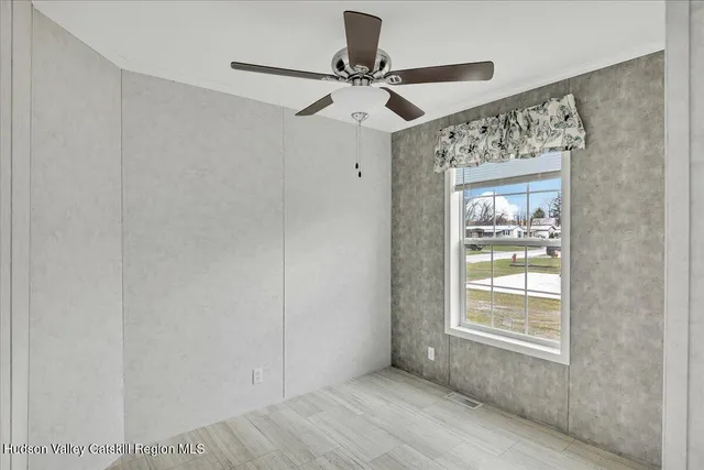 a view of an empty room with a window