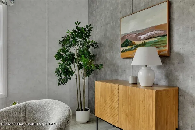 a bedroom with a bed and a potted plant