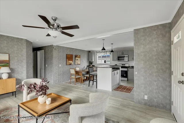 a living room with furniture and kitchen view