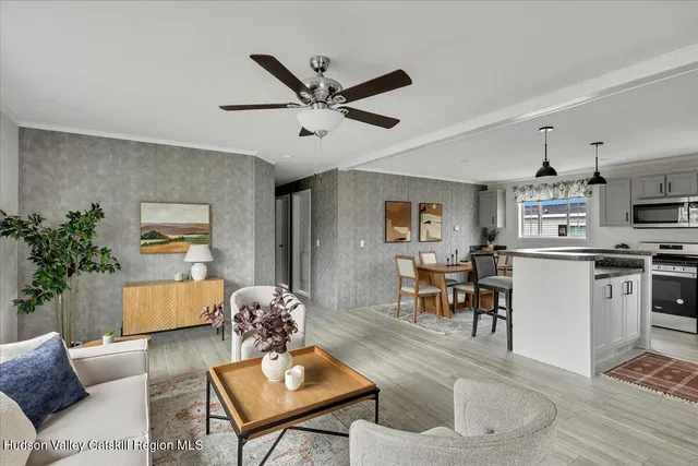 a living room with furniture and kitchen view