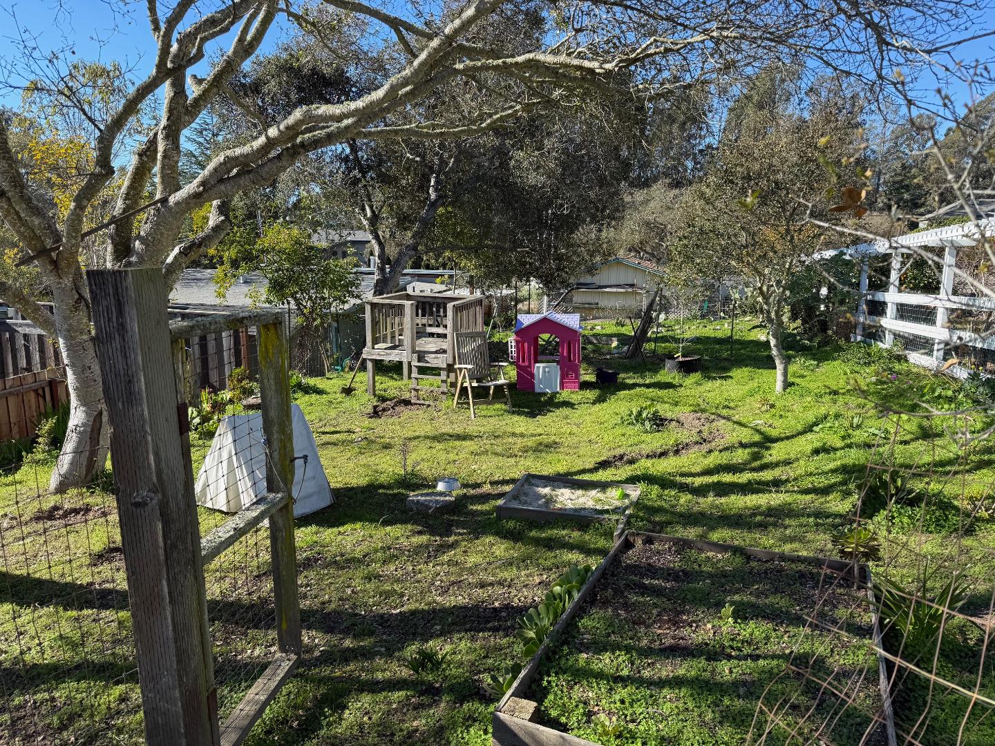 3460 Maplethorpe Lane Soquel, CA 95073 - Photo 13 of 15 a view of a wooden fence and a tree in the background