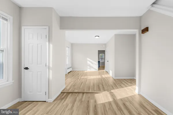 a view of a bedroom with wooden floor and bedroom space