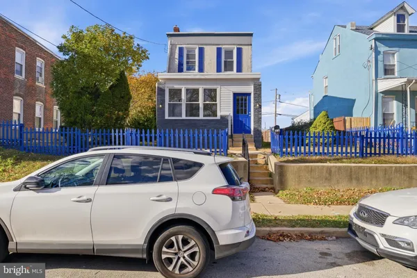 a front view of a house with a parking space