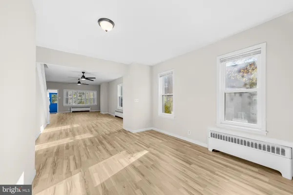 a view of a bedroom with wooden floor and a window