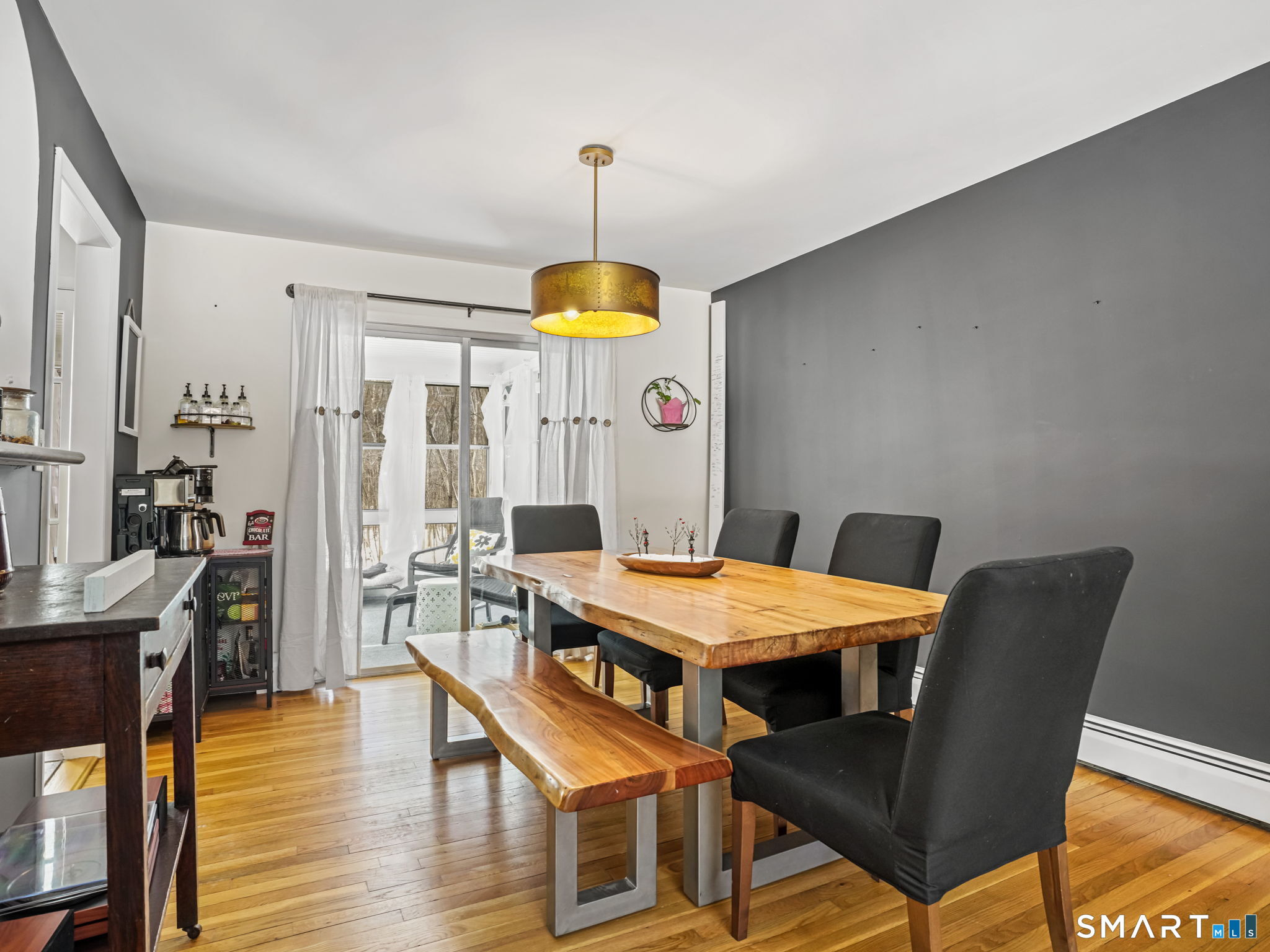 16 Deepdene Road Trumbull, CT 06611 - Photo 6 of 25 a dining room with wooden floor a chandelier a wooden table and chairs
