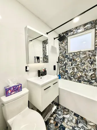 a bathroom with a sink toilet and shower