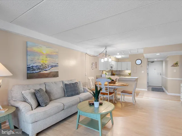 a living room with furniture and a lamp