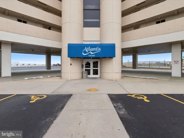 a room with a table chairs and workspace