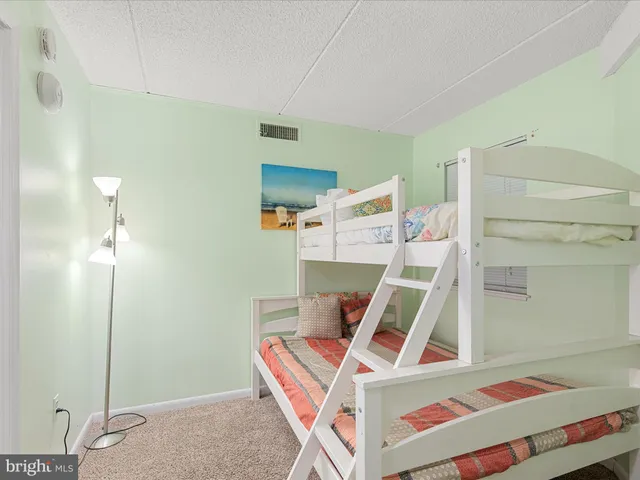a bedroom with furniture and a flat screen tv