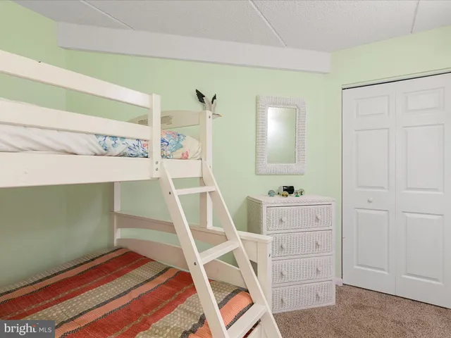 a bathroom with a granite countertop sink a mirror and a shower
