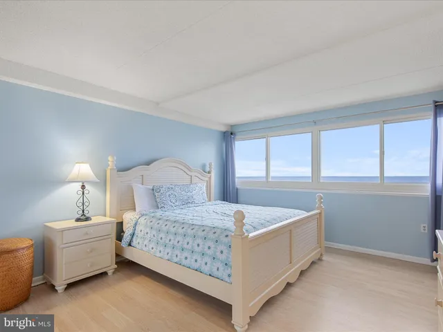 a bedroom with a large bed and a large window