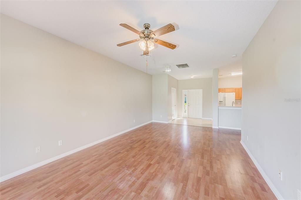 20306 Oak Key Court Tampa, FL 33647 - Photo 11 of 46 an empty room with wooden floor and ceiling fan