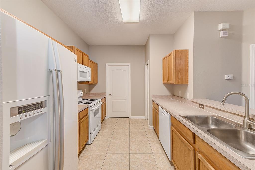 20306 Oak Key Court Tampa, FL 33647 - Photo 16 of 46 a kitchen with a sink stove and refrigerator