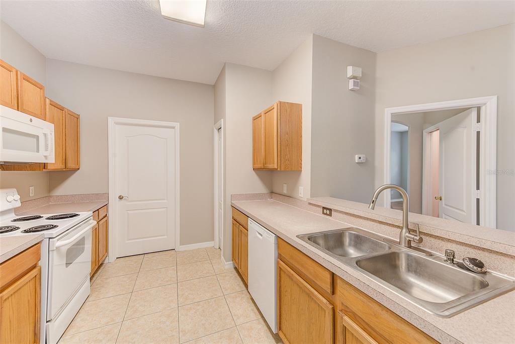20306 Oak Key Court Tampa, FL 33647 - Photo 17 of 46 a kitchen with a sink stove and cabinets