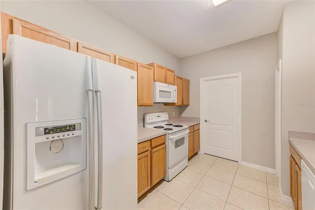 a kitchen with a stove a refrigerator and a sink