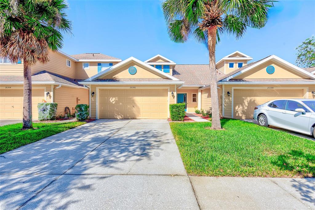 20306 Oak Key Court Tampa, FL 33647 - Photo 2 of 46 a front view of a house with a yard and garage